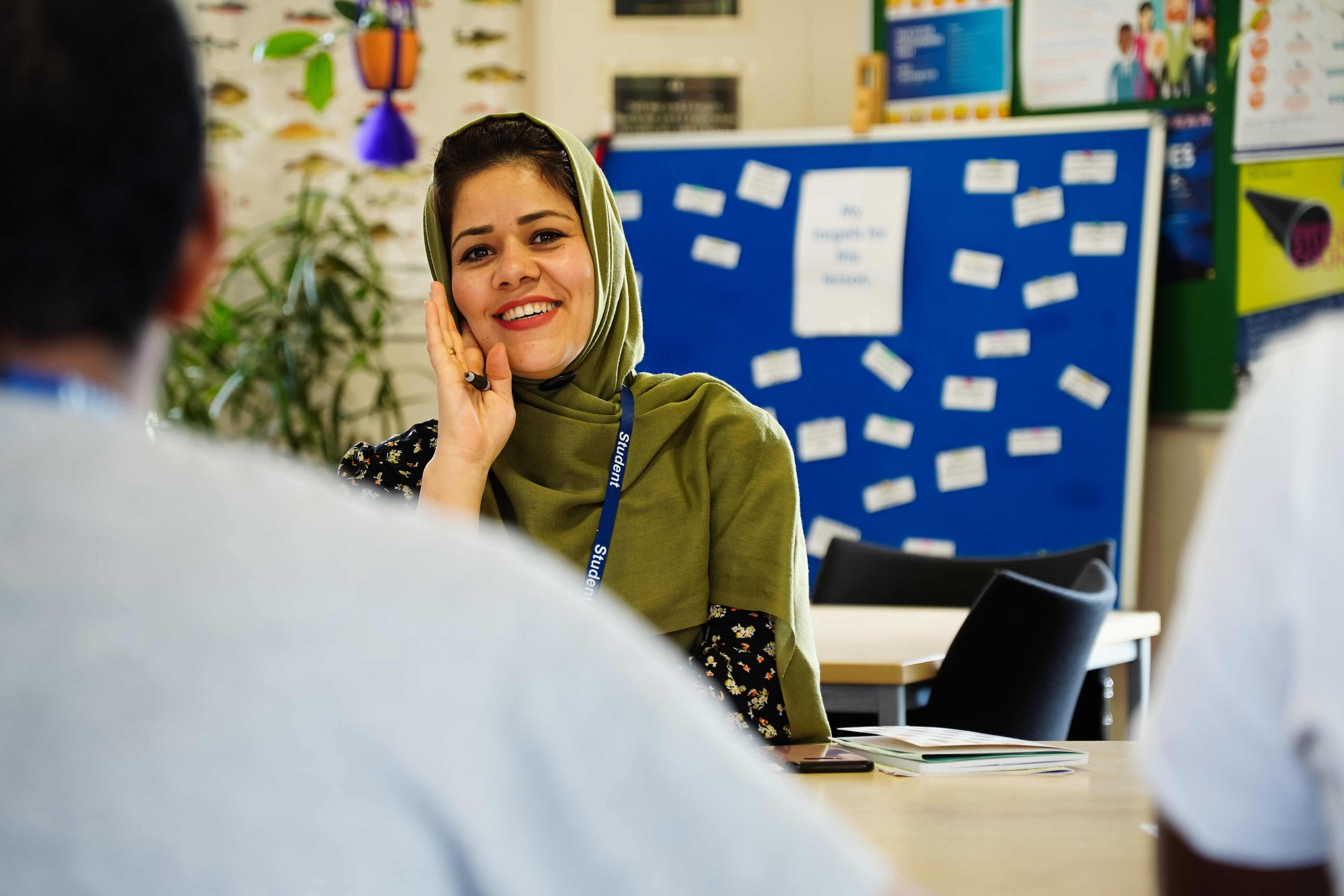 Female student wearing head scarf smiling